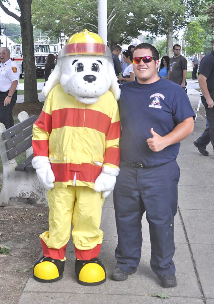 Junior firefighter Colby Dacosta with fellow junior firefighter Griffin Walsh, who donned the new Sparky the Fire Dog costume. - Copyright - Foxboro Reporter Photo